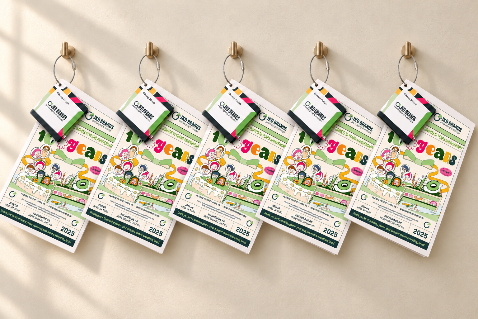 Five anniversary sample packs with finish swatches on a refined ivory display wall
